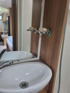a bathroom with a white sink and a mirror at Kościelnik Camp in Kościelnik +29 photos