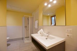 a bathroom with a sink and a shower and a mirror at Marenca Residence in Cannobio +73 photos