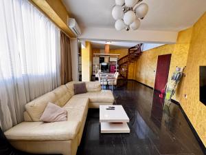 a living room with a couch and a table at Central Point Apartment in Bar
