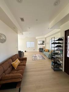 a living room with a couch and a shelf of wine bottles at Qazaq Hostel in Los Angeles