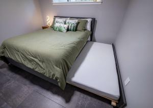 a small bed in a small room with at Remodeled 2BR, Chic and Cozy in Shoreline