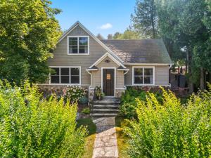 a house with a stone path leading to the front door at Limestone Edge by Simple Life Rentals in Baileys Harbor