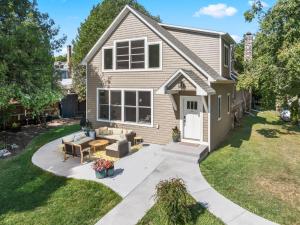 a house with a patio and a lawn at Limestone Edge by Simple Life Rentals in Baileys Harbor