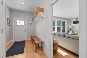 a hallway with a door leading to a living room at Limestone Edge by Simple Life Rentals in Baileys Harbor +60 photos