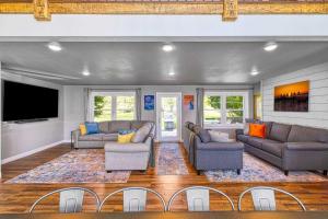 a living room with two couches and a flat screen tv at Westeros by Simple Life Rentals in Ephraim
