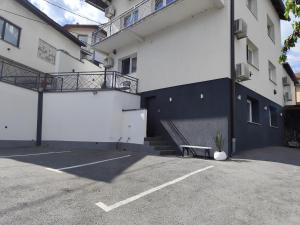 a parking lot with a bench next to a building at Mandrina 10 Free Parking in Sarajevo