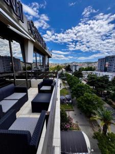 a balcony of a building with couches and a city at Central Point Apartment in Bar