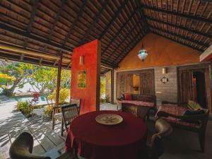 a living room with a table and chairs and a room at Villa Mitirapa in Tohautu
