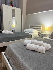 a bedroom with two beds with towels on them at Dimora Leonida in Taranto