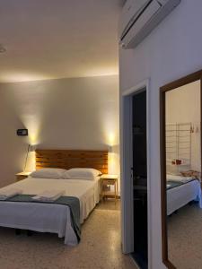 a bedroom with a large bed and a mirror at Castello Di Marà in Cupra Marittima