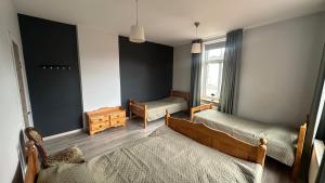 a bedroom with two beds and a window at Kuldiga Kalna Apartment in Kuldīga