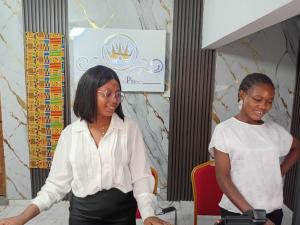 two women standing next to each other at a table at HOTEL DU PRINCE Bingerville in Bingerville