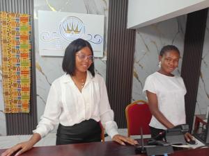 two women standing at a table in a room at HOTEL DU PRINCE Bingerville in Bingerville