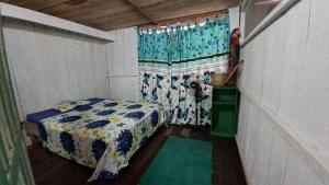 a small room with a bed and a window at Macedonia Lodge in Macedonia