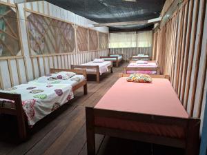 a room with several beds and tables in it at Macedonia Lodge in Macedonia