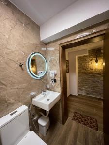 a bathroom with a sink and a mirror at Villa Çabeli in Gjirokastër