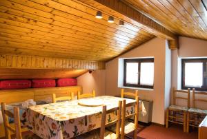 a dining room with a table and chairs at Pian delle Betulle Alpine Loft in Margno