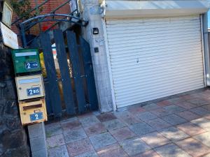 a garage door with a parking meter in front of it at pti caze Hoarau in Le Tampon