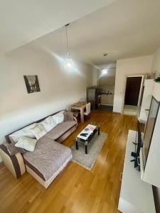 a living room with a couch and a table at Kapije Uba 51 in Ub