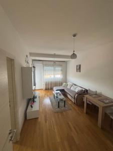 a living room with a couch and a table at Kapije Uba 51 in Ub