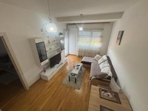 a living room with a couch and a tv at Kapije Uba 51 in Ub