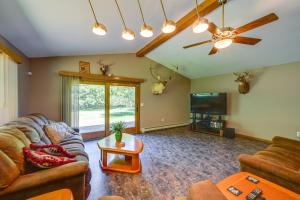 a living room with a couch and a tv at Wooded Applegate Retreat w/ Private Trail Access in Applegate