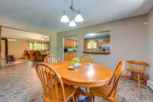 a dining room and living room with a wooden table and chairs at Wooded Applegate Retreat w/ Private Trail Access in Applegate