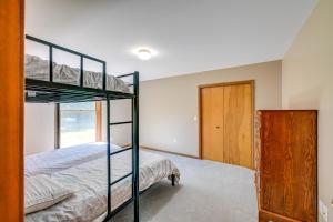 a bedroom with two bunk beds and a door at Wooded Applegate Retreat w/ Private Trail Access in Applegate