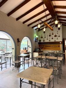 a restaurant with tables and chairs in a room at Terra Campo Posada in Chacras de Coria