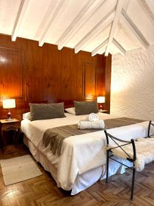 two beds in a room with wooden walls and ceilings at Terra Campo Posada in Chacras de Coria +234 photos