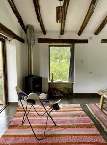 a living room with a chair and a fireplace at Aldealma in Pisac