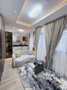 a living room with a couch and a table at Maydec Plus Homes & Apartments in Abuja