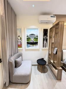 a living room with a couch and a chair at Maydec Plus Homes & Apartments in Abuja