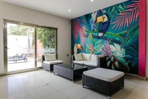 a living room with a large mural on the wall at Hotel Ambra in Playa del Carmen