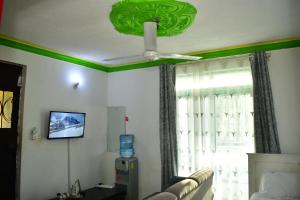 a living room with a couch and a ceiling fan at Oceanic Homes in Mombasa