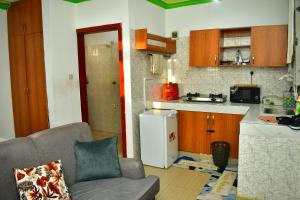 a living room with a couch and a kitchen at Oceanic Homes in Mombasa