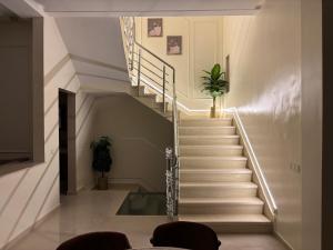 a staircase in a house with a potted plant at Villa Sara, Piscine et Jardin privée in Marrakesh
