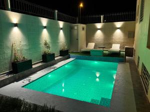 a swimming pool at night with lights on it at Villa Sara, Piscine et Jardin privée in Marrakesh