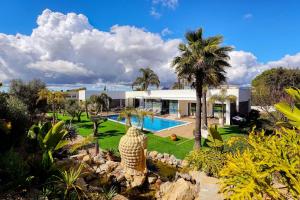 an exterior view of a house with a swimming pool at Palm Suites Algarve in Portimão