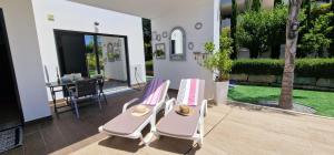 a patio with two chairs and a table at Palm Suites Algarve in Portimão