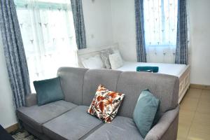 a living room with a couch and a bed at Oceanic Homes in Mombasa