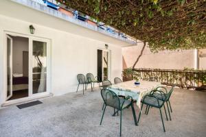 a table and chairs sitting on a patio at Apartment Bogomir in Podgora