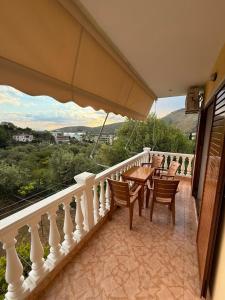 a balcony with a table and chairs and a view at Vila Katerina Qeparo in Qeparo