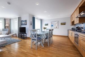 a kitchen and dining room with a table and chairs at No18 The Links Apartment, Brora in Brora