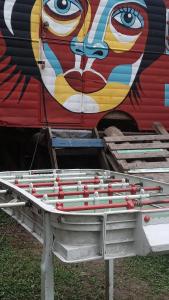 a table in front of a building with a mural at Nuevo Ciclo in Tigre