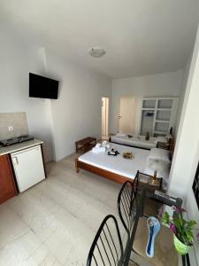 a room with a bed and a table and chairs at Santa Magia in Kamari