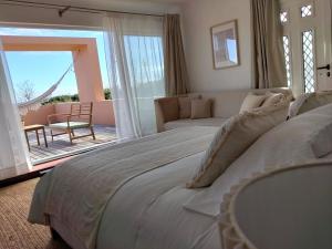 a bedroom with a large bed and a living room at Dona Emília in Horta