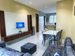 a living room with a couch and a table at Harlequin Diani in Diani Beach