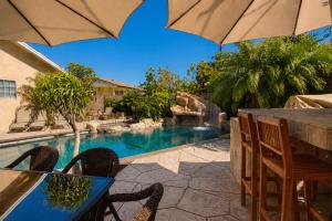 a patio with a table and chairs and a swimming pool at F-13 California Dreamin in Anaheim