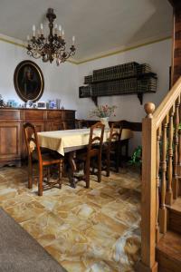 a dining room with a table and chairs and a chandelier at Bed & Breakfast Villa Chiara in Magenta